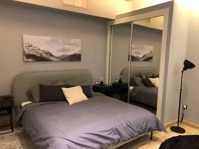 a bedroom with a bed and a large mirror at luxury apartment in boulevard in Amman