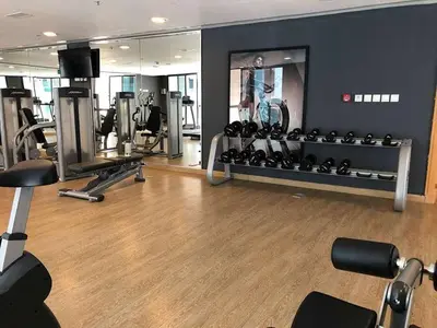a gym with several treadmills and machines in it at luxury apartment in boulevard in Amman