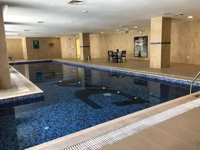 a large swimming pool in a building at luxury apartment in boulevard in Amman
