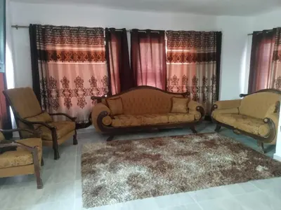 a living room with two chairs and a couch at بوابة جرش الرومانيه الشماليه in Jerash