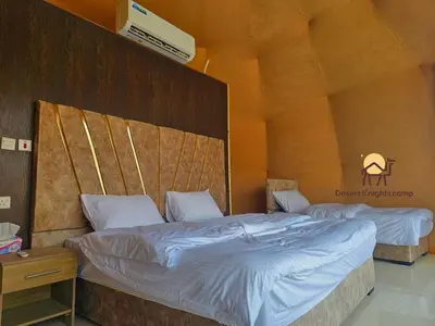 a bedroom with two beds in a room at Desert Knights camp in Wadi Rum