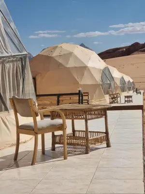 a table and chairs in front of a tent at Desert Knights camp in Wadi Rum