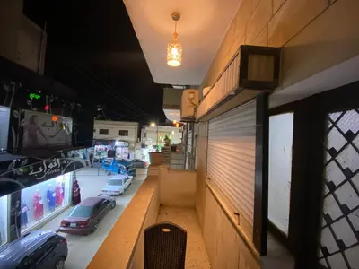 a view of a store with cars on the window at Mesha Stele Private Hotel in Madaba