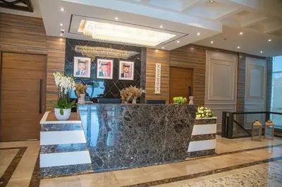 a lobby of a hotel with a reception desk at Jeddah Homes Boutique Hotel in Amman