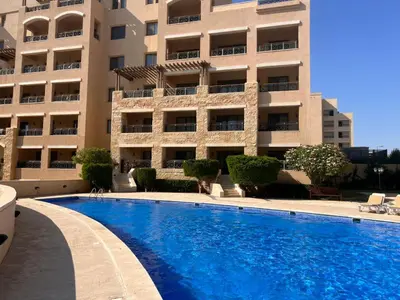 a large swimming pool in front of a building at Apartment at Samarah Dead Sea Resort APT D-09 in Sowayma
