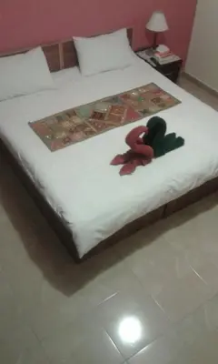 a bed with two stuffed animals sitting on it at Jordan River Hotel in Amman