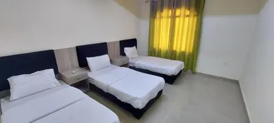 a hotel room with two beds and a window at Venice in Aqaba