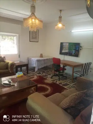 a living room with a couch and a table at Decapolis in Irbid