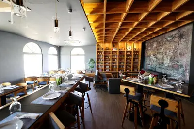 a restaurant with long tables and chairs in a room at Lavanda Boutique Suites Tala Bay in Aqaba