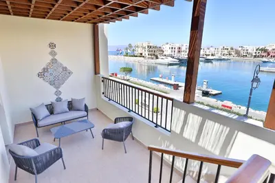 a balcony with chairs and a view of the water at Lavanda Boutique Suites Tala Bay in Aqaba