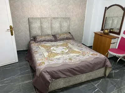 a bedroom with a bed and a mirror on the wall at huseein rooms in Jerash