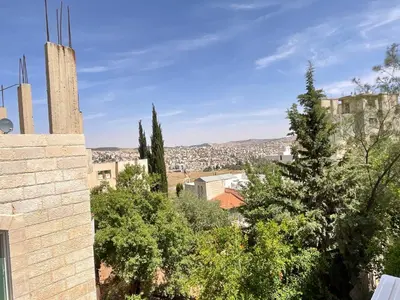 a view of a city from a building at Black IRIS in Jerash