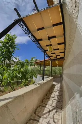 an external view of a building with awning over a sidewalk at Fragrant Rose in Wadi Musa