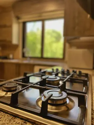 a stove top in a kitchen with a window at Fragrant Rose in Wadi Musa