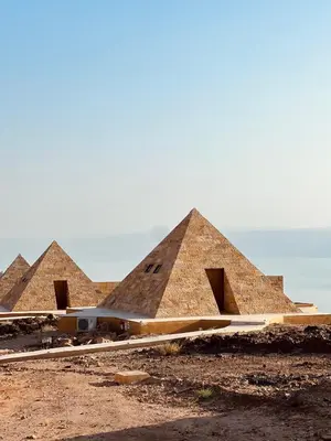a group of pyramids in a dirt field at Deadsea OCTAGON in Madaba
