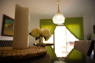 a table with a candle and a vase of flowers on it at Sunset apartment in Samarah Dead Sea resort in Sowayma