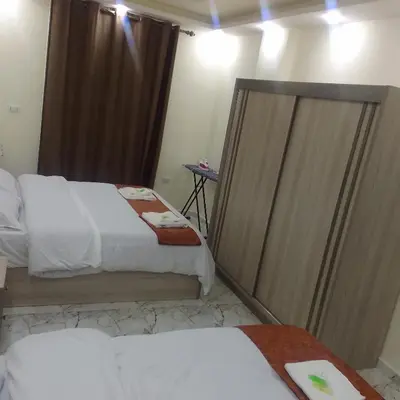 a hotel room with two beds and a mirror at Dream house hotel jerash in Jerash