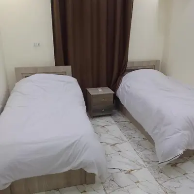 two beds sitting next to each other in a room at Dream house hotel jerash in Jerash