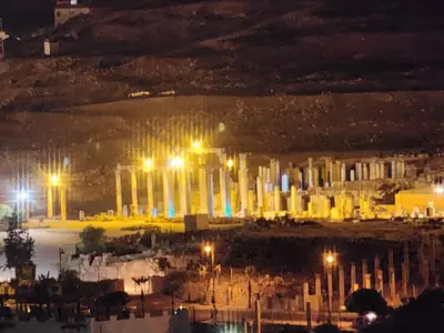 a view of a city at night with lights at Dream house hotel jerash in Jerash