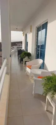 a balcony with couches and tables on a building at AQABA PRO DIVERS in Aqaba