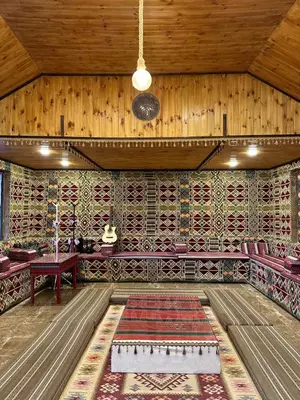 an empty room with a table and a rug at Full moon camp in Wadi Rum