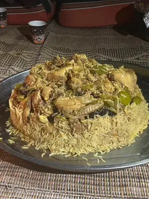a plate of food on a table with noodles at Wadi Rum Best Tours in Wadi Rum