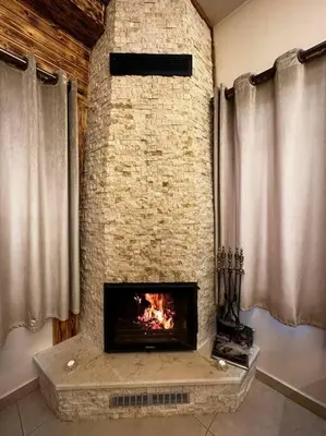 a fireplace in a room with a brick wall at Oak Farm Ajloun مزرعة البلوط عجلون in Ajloun