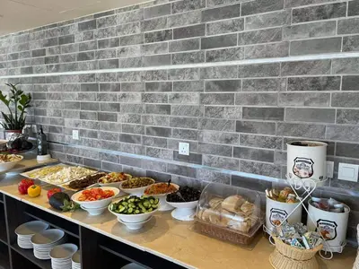 a buffet with many bowls of food on a counter at De-Lara hotel in Aqaba