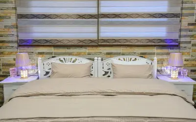 a bedroom with a white bed with two night stands at PETRA ROYAL HOUSE in Wadi Musa