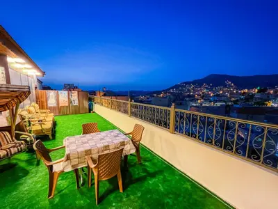 a balcony with a table and chairs and a view at PETRA ROYAL HOUSE in Wadi Musa