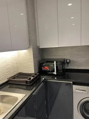 a kitchen with a sink and a microwave at Modern studio in the heart of Amman in Amman