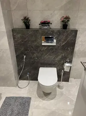 a bathroom with a white toilet in a room at Modern studio in the heart of Amman in Amman