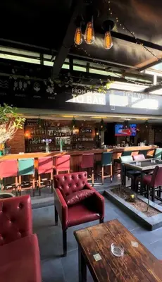 a restaurant with chairs and tables and a bar at Boho Boutique Hotel Amman in Amman