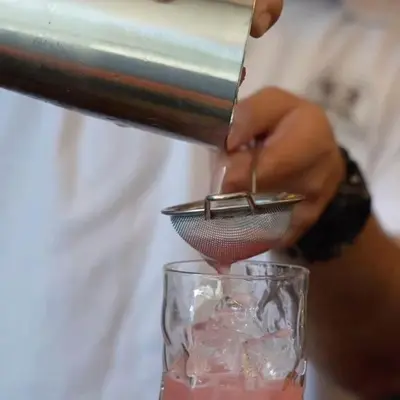 a person is preparing a drink in a glass at Boho Boutique Hotel Amman in Amman