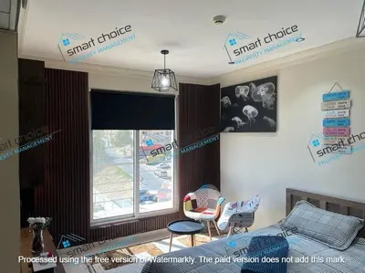 a living room with a bed and a window at fancy apartment gardens st 410 in Umm Uthainah