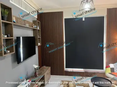 a living room with a large black screen in a room at fancy apartment gardens st 410 in Umm Uthainah