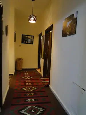a hallway with a rug on the floor of a room at ( b&b ) Gadara rent room in Um Qeis