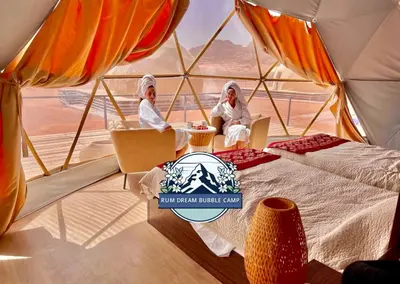 two women sitting in a tent in the desert at RUM DREAM BUBBLES lUXURY CAMP in Wadi Rum
