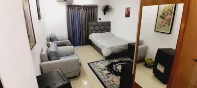 a living room with a couch and a bed at MK1 - Studio Stay in Amman