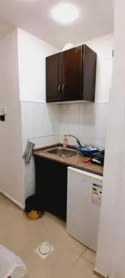 a small kitchen with a sink and a refrigerator at MK1 - Studio Stay in Amman