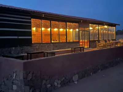 a building with lights on the side of it at Salameh's Bedouin Camp in Wadi Rum