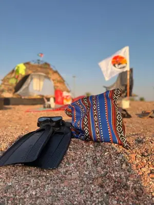 a tie and a pillow on the ground with a tent at Extra Traveller in Aqaba