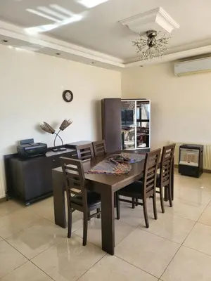 a dining room with a table and chairs at MK6 - Two bedroom Apartment in Amman