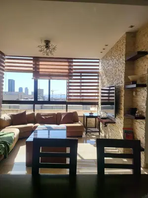 a living room with a couch and a table at MK6 - Two bedroom Apartment in Amman