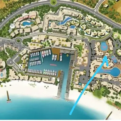 a map of a resort with a blue arrow at Lovely first floor tow bed rooms overviewing circular pool for families only in Talabay Aqaba in Aqaba