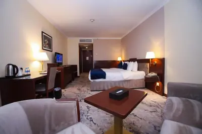 a hotel room with a bed and a desk at Amman Paradise Hotel in Amman