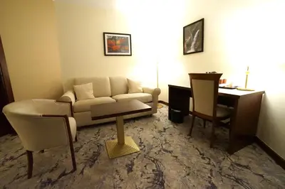 a living room with a couch and a table at Amman Paradise Hotel in Amman