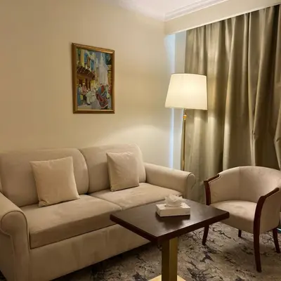 a living room with a couch and a table at Amman Paradise Hotel in Amman