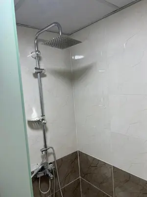 a bathroom with a shower with a shower head at Queen's Magic Camp in Wadi Rum