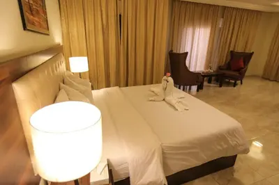 a hotel room with a bed with towels on it at LANCASTER HOTEL APARTMENTS DAHIET ALRASHEED in Amman